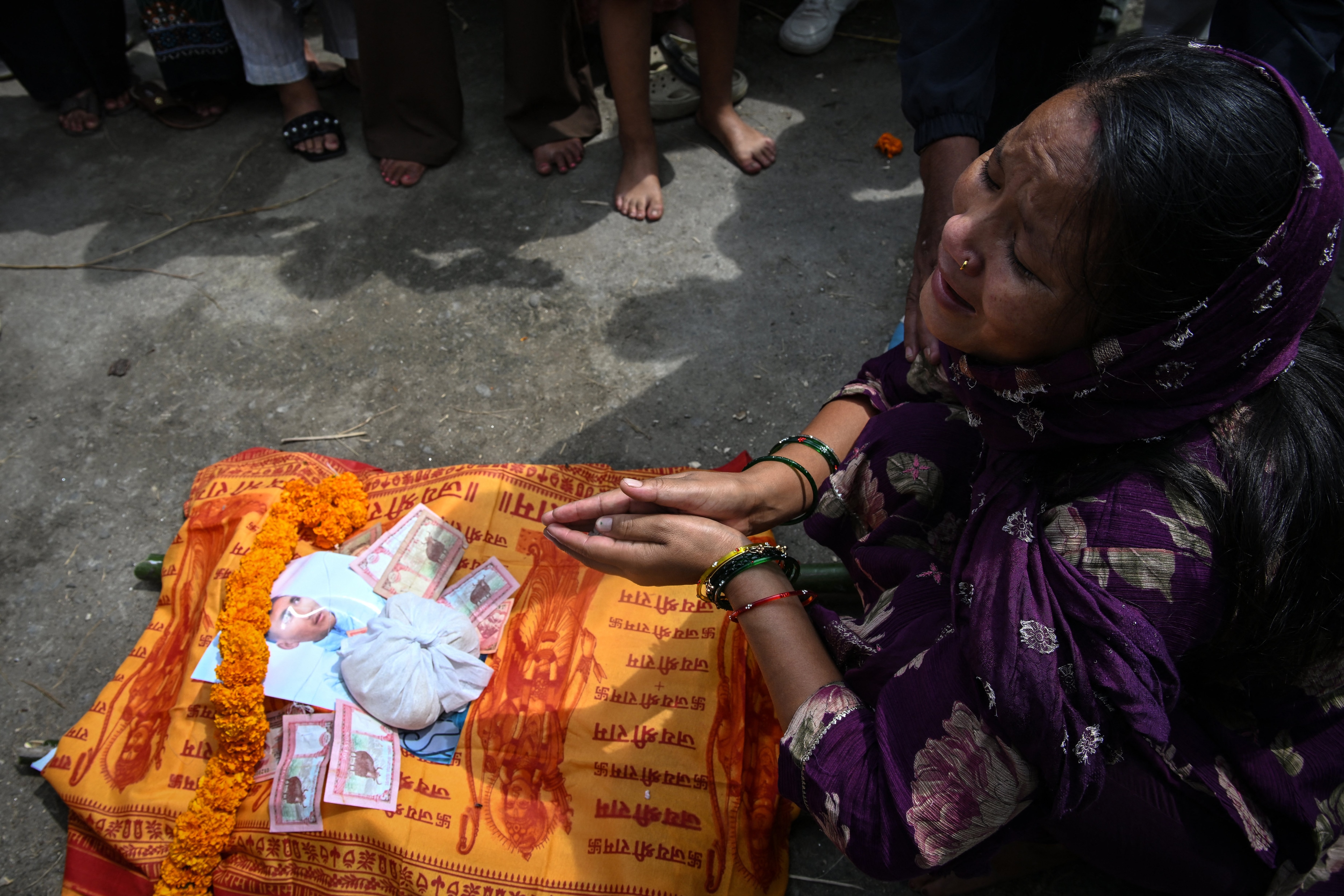 Bimala Rokaya, wife of Mohan Lal Rokaya, who is still reported missing, breaks down during his symbolic funeral ceremony at the Pashupatinath temple in Kathmandu on September 18. (Image: AFP)