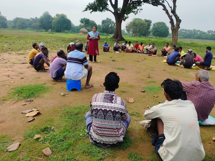Community members gather for a discussion in the village