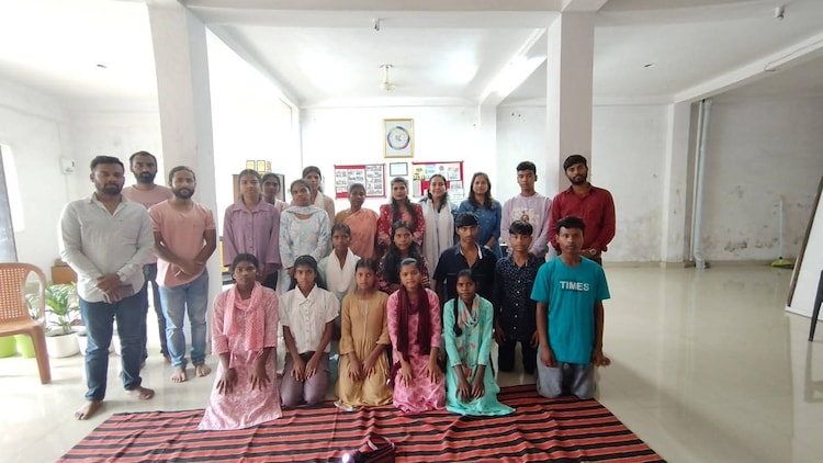 A group of students and community members gathered during an education programme in the village.