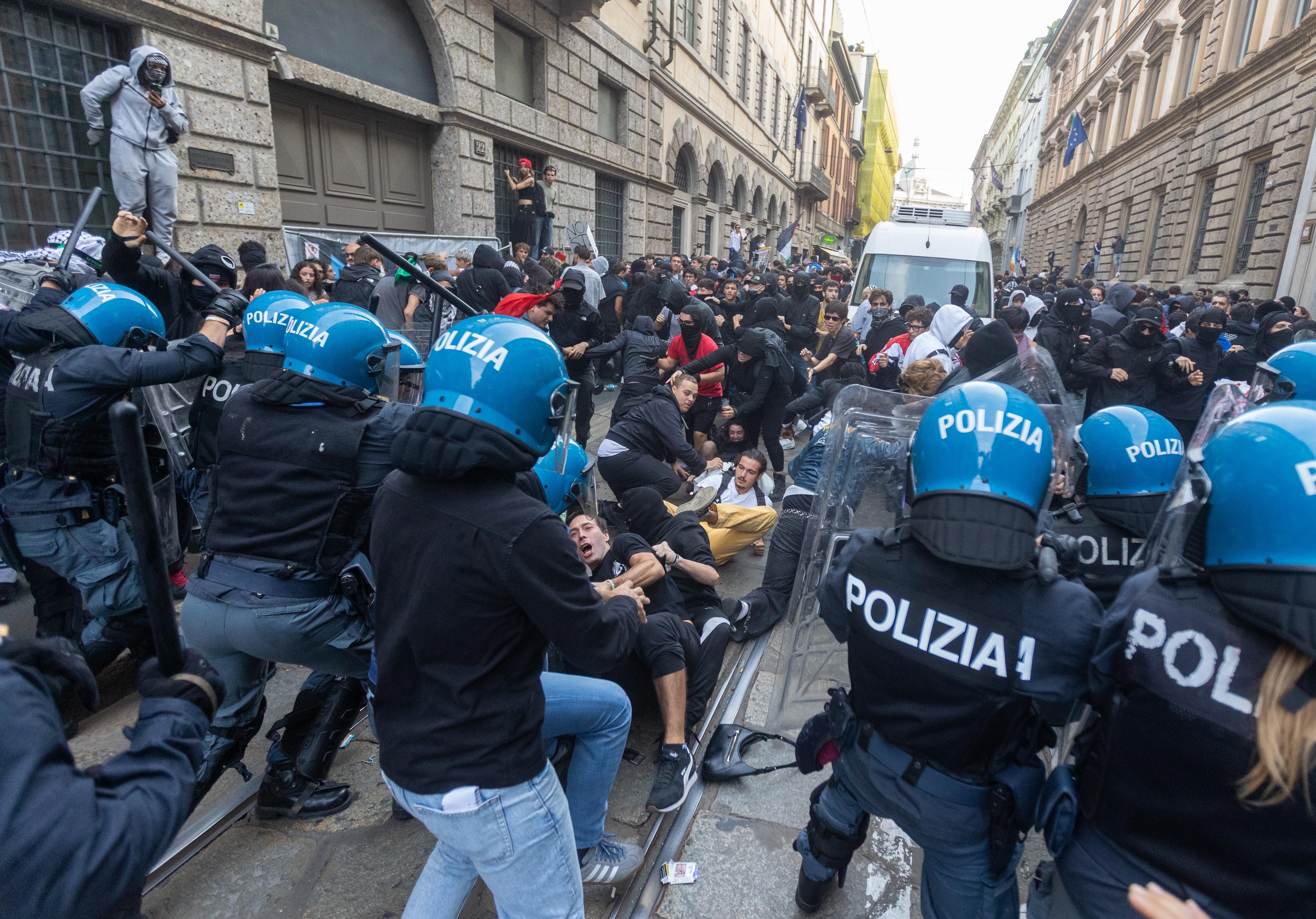 Demonstrators clash with riot police during a protest in Milan, Italy, on October 17. (Stefano Porta/LaPresse via AP)