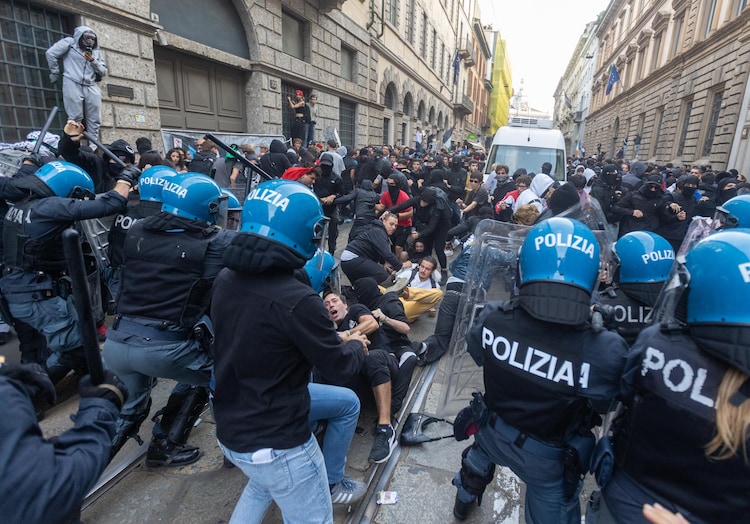 Demonstrators clash with riot police during a protest in Milan, Italy, on October 17. (Stefano Porta/LaPresse via AP)