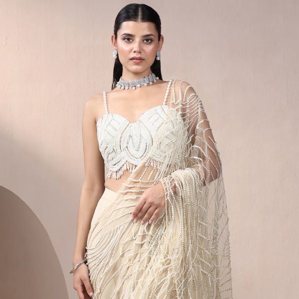 https://akm-img-a-in.tosshub.com/lingo/brt/images/photo_gallery/202510/chaashni_by_maansi_and_ketan_ivory_net_chiffon_pearls_beads_embroidered_pre-draped_saree_with_blouse_rs58995_0.jpg