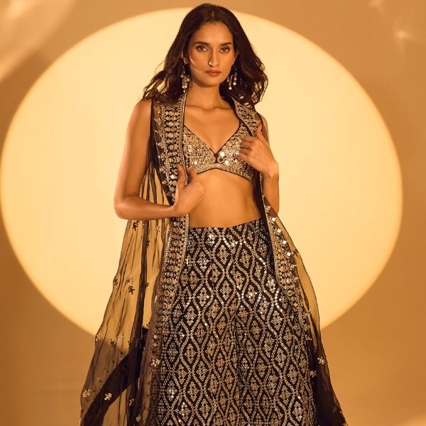 https://akm-img-a-in.tosshub.com/lingo/brt/images/photo_gallery/202510/gopi_vaid_black_tussar_mirrors_zari_v-neck_embroidered_cape_and_flared_pant_set_rs77000_2.jpg
