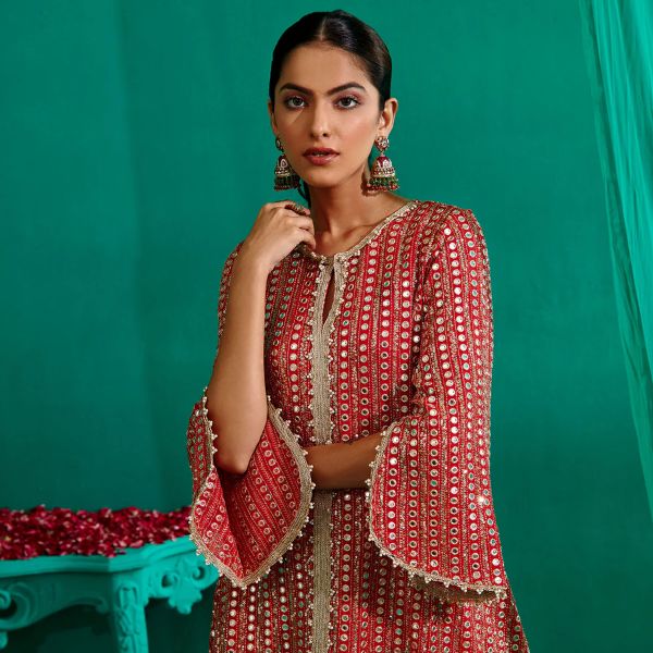 https://akm-img-a-in.tosshub.com/lingo/brt/images/photo_gallery/202510/mustard_moon_by_neyha_and_vrinda_red_georgette_satin_mirrors_asymmetric_embroidered_kurta_with_tulip_pant_rs26000_2.jpg