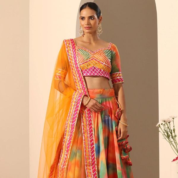https://akm-img-a-in.tosshub.com/lingo/brt/images/photo_gallery/202510/pomcha_jaipur_orange_georgette_net_tassels_gota_patti_sweetheart_gul_rangbirangi_lehenga_set_rs36197.jpg