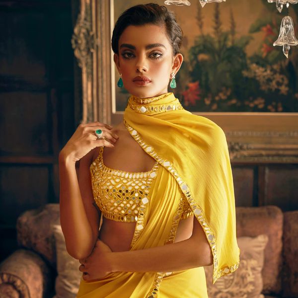 https://akm-img-a-in.tosshub.com/lingo/brt/images/photo_gallery/202510/seema_gujral_yellow_georgette_mirrors_scoop_neck_pre-draped_saree_with_work_blouse_rs72000_2.jpg