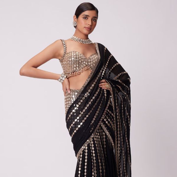 https://akm-img-a-in.tosshub.com/lingo/brt/images/photo_gallery/202510/vvani_by_vani_vats_black_georgette_mirrors_cut_sheesha_vine_embroidered_lehenga_saree_with_blouse_rs85500_2.jpg