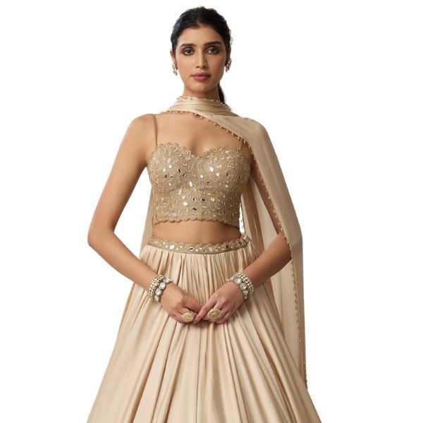 https://akm-img-a-in.tosshub.com/lingo/brt/images/photo_gallery/202511/vvani_by_vani_vats_beige_satin_georgette_mirrors_embroidery_pom-poms_corset_blouse_lehenga_set_rs84500.jpg