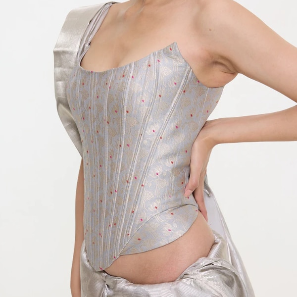 https://akm-img-a-in.tosshub.com/lingo/brt/images/photo_gallery/202601/ekaya_handwoven_grey_silk_cutwork_corset_rs24975.png