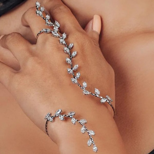 https://akm-img-a-in.tosshub.com/lingo/brt/images/photo_gallery/202601/ishaara_boho_adjustable_leaf_cubic_zircon_hand_cuff_rs3999.png