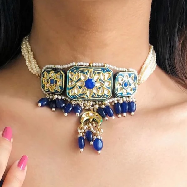 https://akm-img-a-in.tosshub.com/lingo/brt/images/photo_gallery/202602/ajnaa_blue_meenakari_choker_necklace_rs6500_0.png