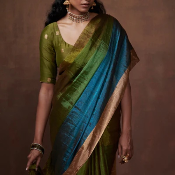 https://akm-img-a-in.tosshub.com/lingo/brt/images/photo_gallery/202603/vyom_green_olive-turquoise_tissue_saree_with_gold_borders_rs11700.png