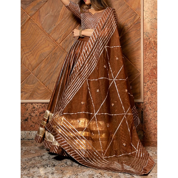 https://akm-img-a-in.tosshub.com/lingo/brt/images/photo_gallery/202606/pomcha_jaipur_brown_cotton_silk_gota_work_lehenga_set_rs34979.png
