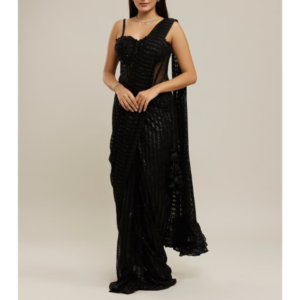 https://akm-img-a-in.tosshub.com/lingo/brt/images/photo_gallery/202607/twamev_black_georgette_velvet_floral_bead_work_corset_ruffle_draped_saree_rs26999.png