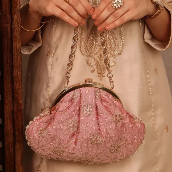 https://akm-img-a-in.tosshub.com/lingo/brt/images/photo_gallery/202608/amyra_tarang_cutwork_vintage_purse_rs3799.png