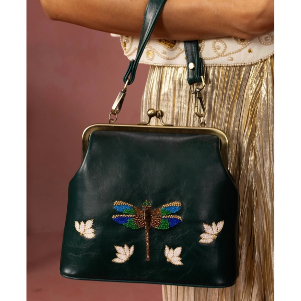 https://akm-img-a-in.tosshub.com/lingo/brt/images/photo_gallery/202608/miri_dragonfly_hand_embroidered_70s_kisslock_clutch_rs5950.png
