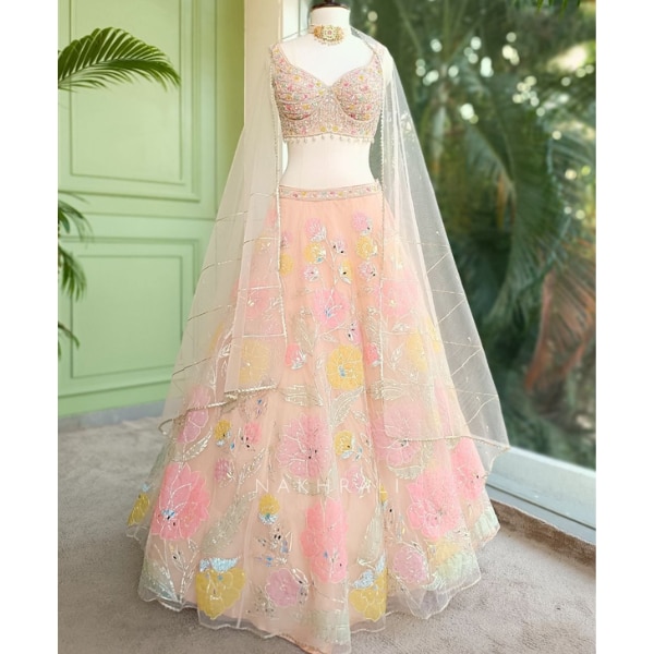 https://akm-img-a-in.tosshub.com/lingo/brt/images/photo_gallery/202608/nakhrali_gulbahar_peach_organza_floral_lehenga_with_mirror_thread_work_rs23895.png