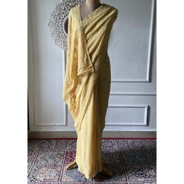https://akm-img-a-in.tosshub.com/lingo/brt/images/photo_gallery/202609/nazrana_yellow_viscose_georgette_chikankari_saree_rs10500.png