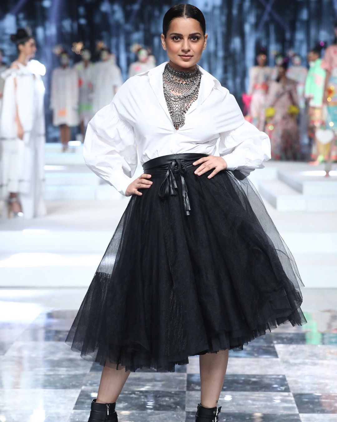 Skirt and oversized shirt make a modish