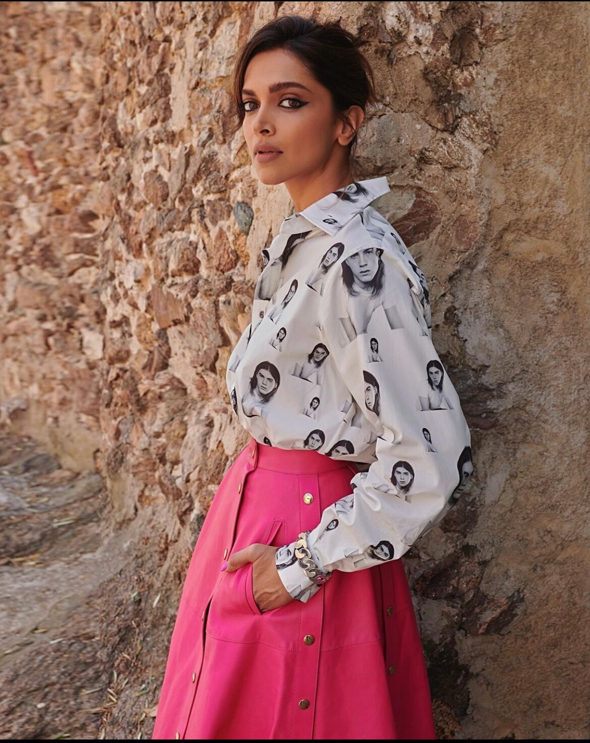 Deepika's next 0ff-duty look was a printed blouse paired with a pink  flared skirt by Louis Vuitton