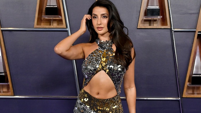 Nora Fatehi attends the 2025 AMAs in a sparkling cutout Tom Ford creation