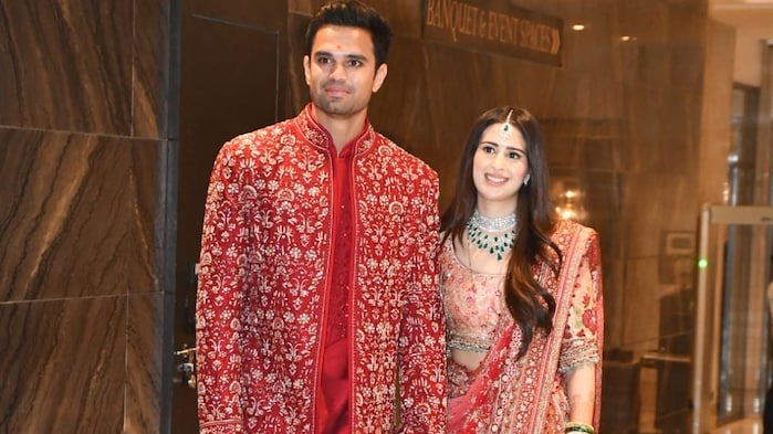 Arjun Tendulkar and Saaniya Chandok are resplendent in red for their wedding reception