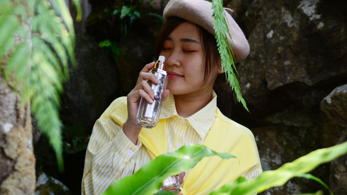 Girl holding perfume