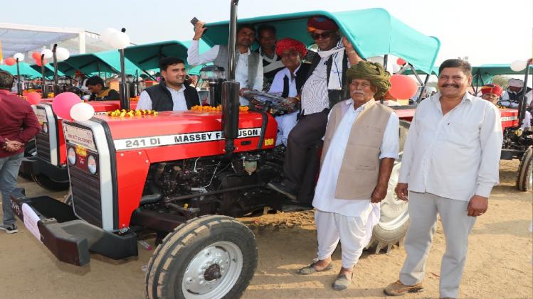 ट्रैक्टरों के साथ लाभार्थी किसान.