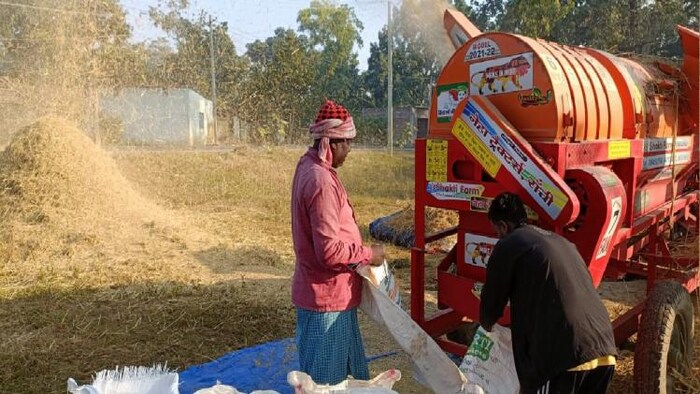 धान की सफाई करता एक किसान