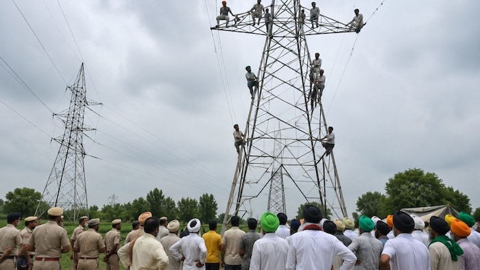 Farmers Climb HT Line Tower