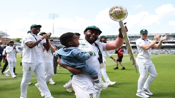Temba Bavuma holds his son with one hand and WTC mace with the other Temba Bavuma holds his son with one hand and WTC mace with the other