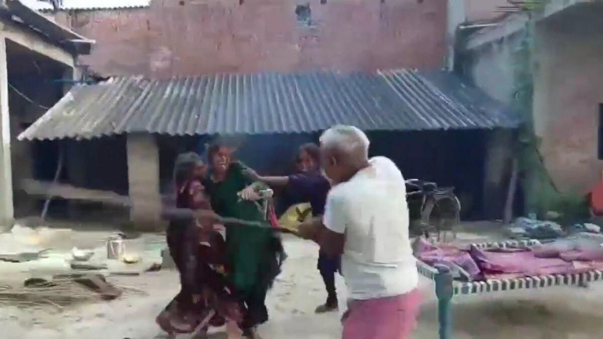 महिला और उसकी बेटियों की पिटाई करता पड़ोसी. (Photo: Screengrab)