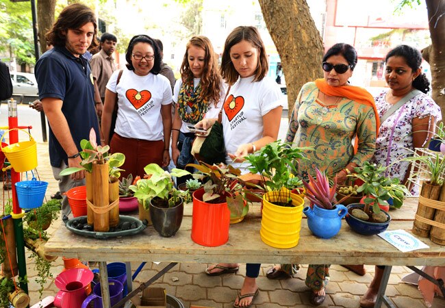 Visitors crowd around a low-maintenance green shop at the street festival. (Photo: Nilotpal Baruah)