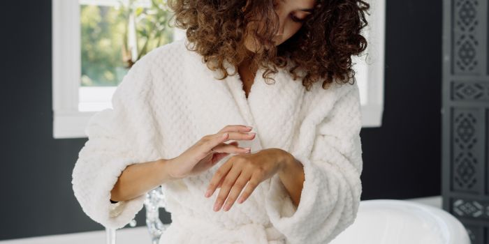 Woman putting moisturiser on skin