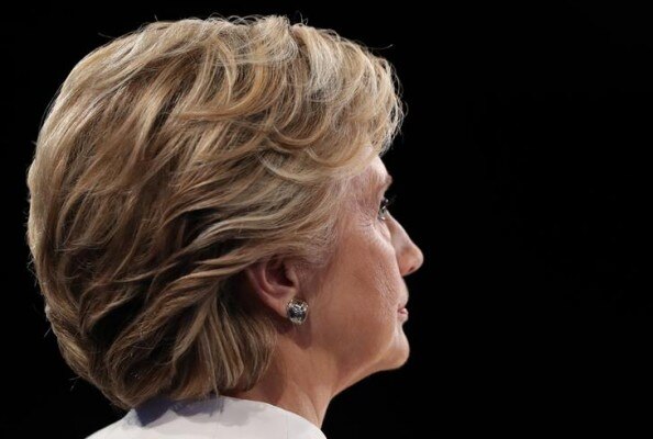Democratic U.S. presidential nominee Clinton listens as Republican U.S. presidential nominee Trump speaks during their third and final 2016 presidential campaign debate at UNLV in Las Vegas