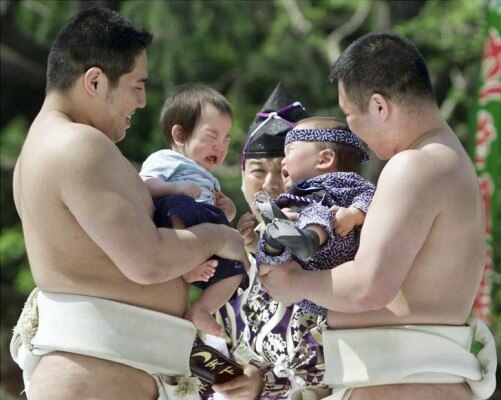 Two babies held by amateur sumo wrestlers burst into tears during a baby-crying contest to determine..