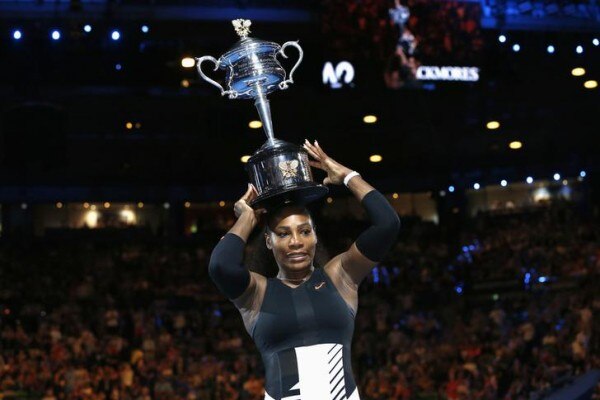 Tennis - Australian Open - Melbourne Park, Melbourne, Australia - 28/1/17 Serena Williams of the U.S. places her trophy on her head after winning her Women's singles final match against Venus Williams of the U.S. .REUTERS/Issei Kato TPX IMAGES OF THE DAY