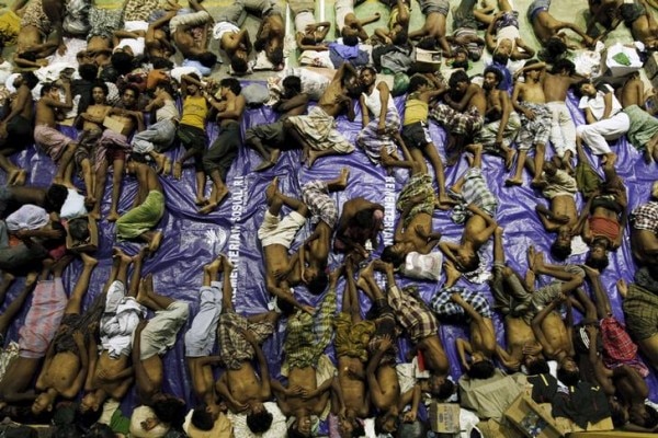 Migrants believed to be Rohingya rest inside a shelter after being rescued from boats at Lhoksukon in Indonesia's Aceh Province May 11, 2015. Nearly 600 migrants thought to be Rohingya refugees from Myanmar were rescued from two wooden boats stranded off the coast of Indonesia's northern Aceh province, authorities said on Sunday. The overcrowded boats, which were carrying nearly 100 women and dozens of children among the refugees, were towed to shore by fishermen after running out of fuel. REUTERS/Roni Bintang TPX IMAGES OF THE DAY