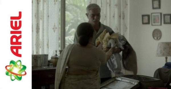 Helping his wife with laundry