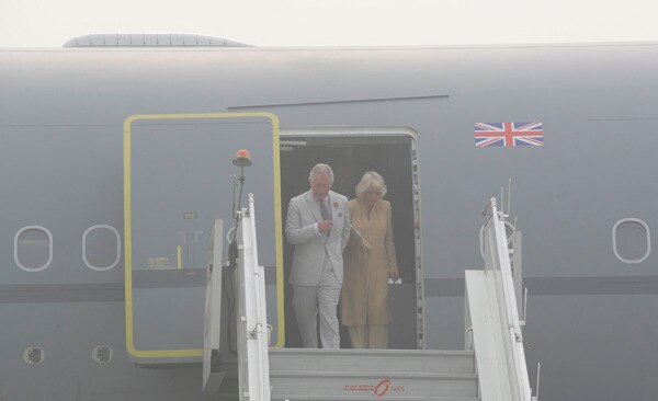 Britain's Prince Charles and his wife Camilla, Duchess of Cornwall, alight from an aircraft surrounded by smog, after landing in New Delhi, India, Wednesday, Nov. 8, 2017. The royal couple are in the country on a two-day visit (AP Photo/Manish Swarup)