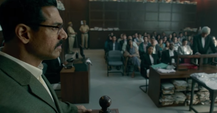 फिल्म के एक कोर्ट सीक्वेंस में जॉन और राजेश शर्मा. यहां फिल्म डायलॉग्स के लिए अपनी पीठ खुद ही थपथपा लेती है.
